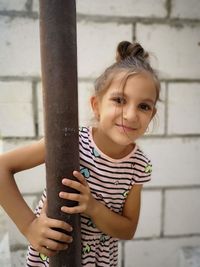 Portrait of smiling girl standing outdoors