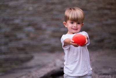 Portrait of smiling boy holding camera