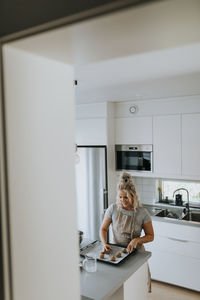 Woman preparing cookies in kitchen