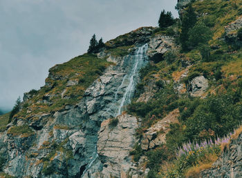 Small waterfall making its way through the mountain rock