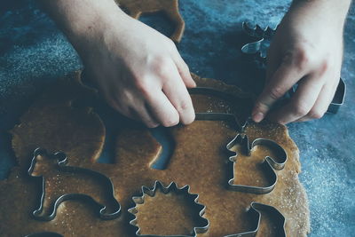 Close up of man baking gingerbread cookies for christmas