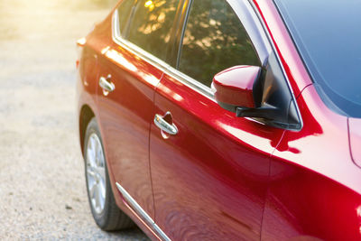 Close-up of red car on road