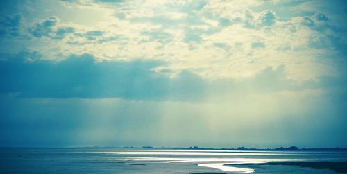 Scenic view of sea against cloudy sky