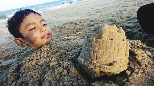 Close-up of cute girl on sand at beach