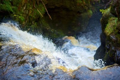 Water flowing through rocks in sea