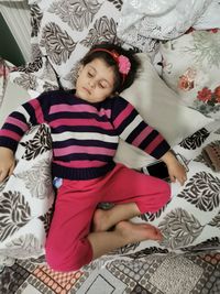 High angle view of baby lying on bed at home