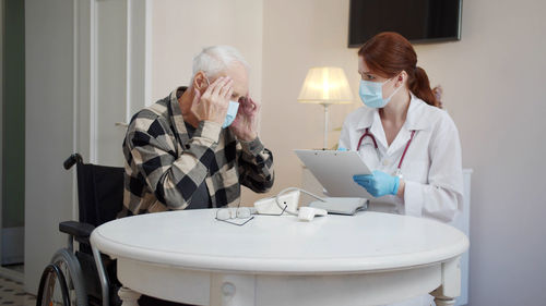 Senior man talking to nurse