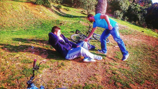 leisure activity, lifestyles, field, casual clothing, full length, grass, childhood, men, blue, shoe, day, outdoors, standing, sunlight, grassy, jeans, tree, nature