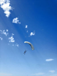 Low angle view of kite flying against blue sky