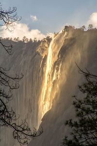 Scenic view of waterfall against sky