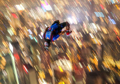 Blurred motion of people on illuminated city at night