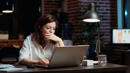 Young woman using laptop at office