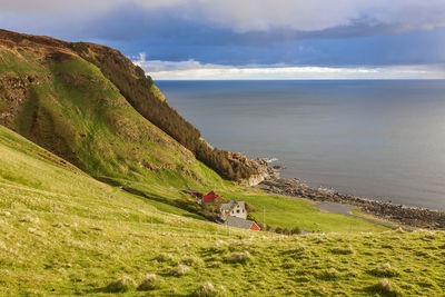 Rocky coastline and a farm at the sea in norway