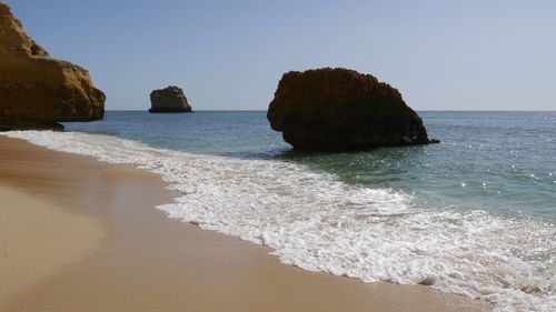 Lonely sandy beach with rocks at coastline, algarve