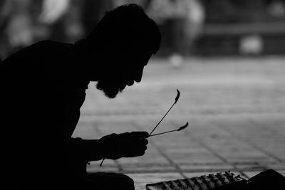 Close-up of man playing music on street