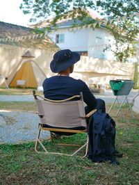 Rear view of man sitting on chair