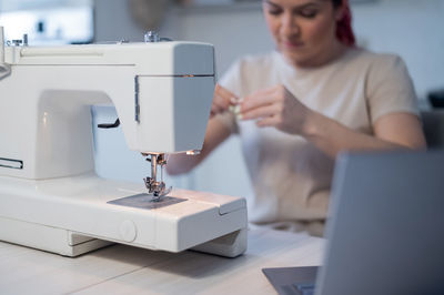 Midsection of woman working on table