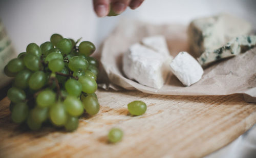 Close-up of person preparing food on cutting board