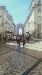 Rear view of people on street in city