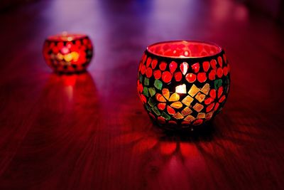 Close-up of illuminated lamp on table