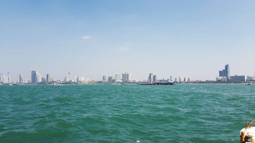 Scenic view of sea and buildings against sky