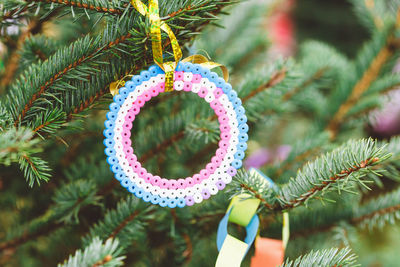 Handmade plastic beads corcle decoration on christmas tree. diy ideas for children