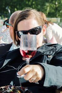 Close-up of woman holding sunglasses