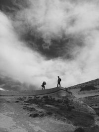 Silhouette of woman against cloudy sky