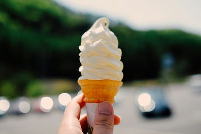 Cropped hand holding ice cream cone