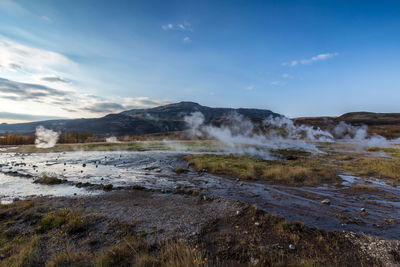 Smoke emitting from hot spring geyser