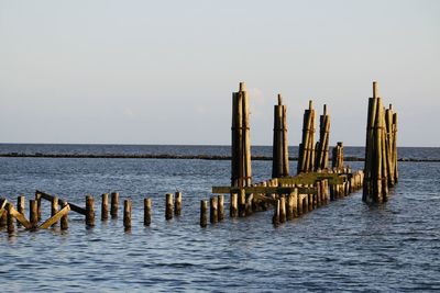 Pier over sea against clear sky