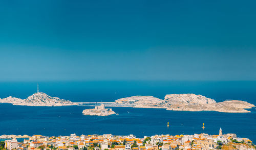 Sailboats in sea against blue sky