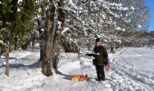 Woman with dog in snow