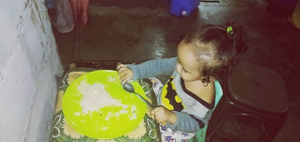 High angle view of girl holding food