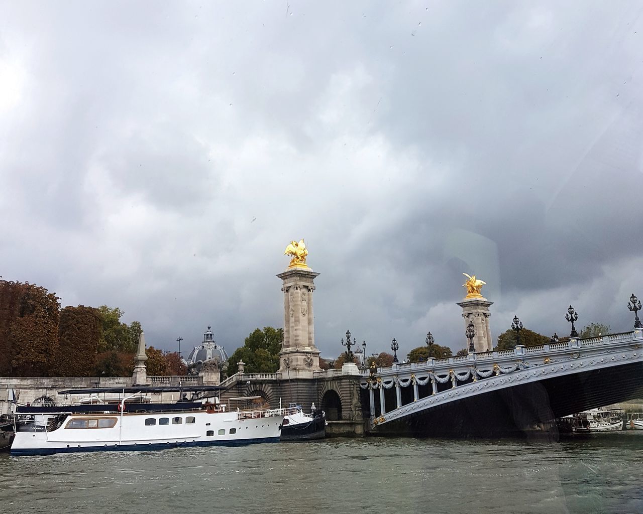 LOW ANGLE VIEW OF BRIDGE OVER RIVER IN CITY