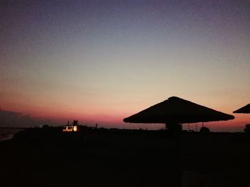 Silhouette built structure against sky during sunset