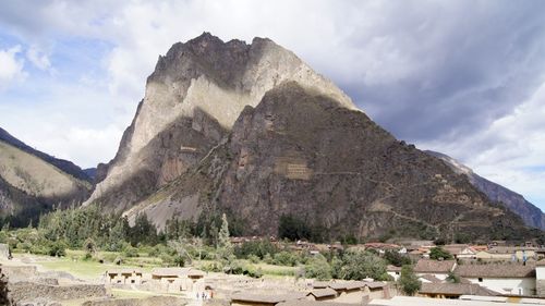 Castle on mountain against cloudy sky