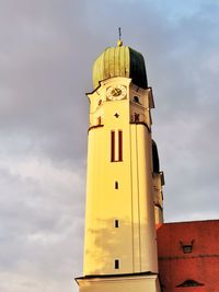 Low angle view of lighthouse against building