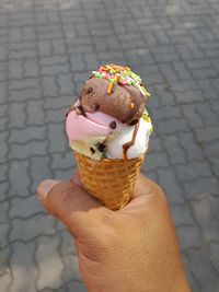 Close-up of hand holding ice cream cone