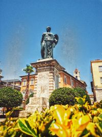 Low angle view of statue against building