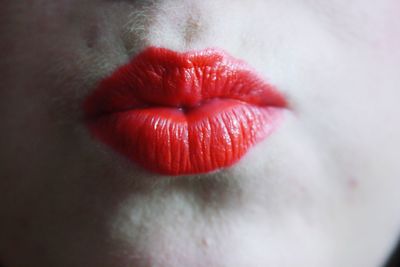 Close-up of young woman puckering lips