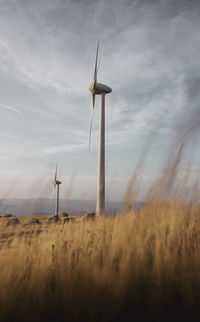 Windmill on field against sky