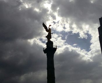 Low angle view of statue against cloudy sky