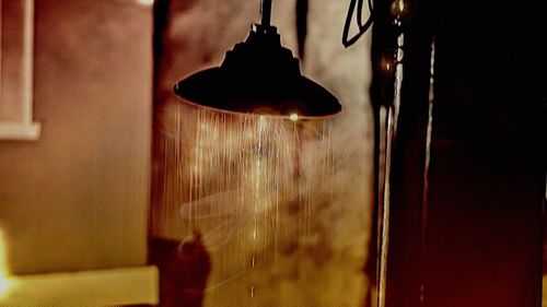 Close-up of lamp against wall