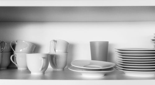 Tea cups with saucers in shelf