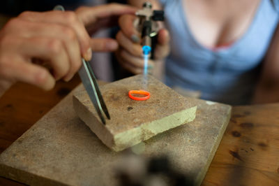 Cropped image of hands making ring