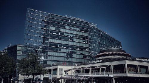 Low angle view of modern building against clear blue sky