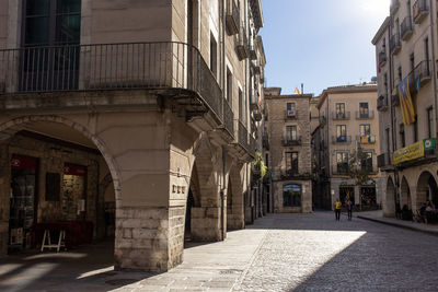 Street amidst buildings in city,  girona, spain..