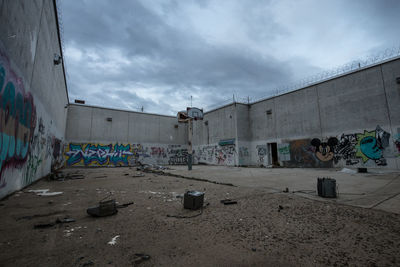 Abandoned building against cloudy sky