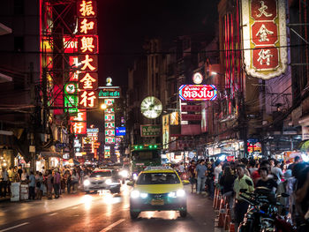 Cars on city street at night